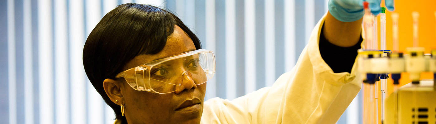 Researcher picking up test tube from machine